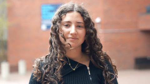 A student is looking at the camera.