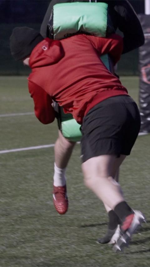 Rugby player tackling another player in a practice game