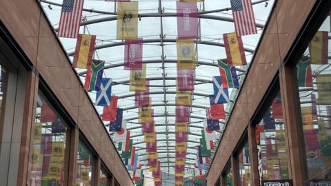 Various national flags hung from the ceiling of a shopping centre in Exeter.