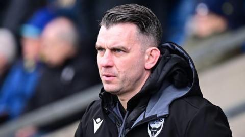 Oxford United boss Matt Bloomfield looks on from the sidelines 
