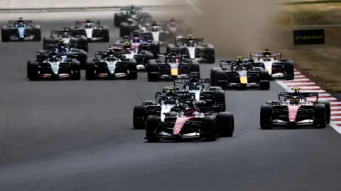 Ferrari's Charles Leclerc leads the field into the first corner of the 2026 British Grand Prix