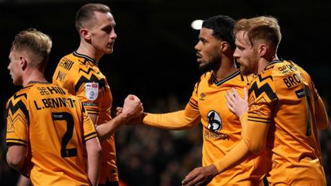 Cambridge celebrate Elias Kachunga's goal against Exeter