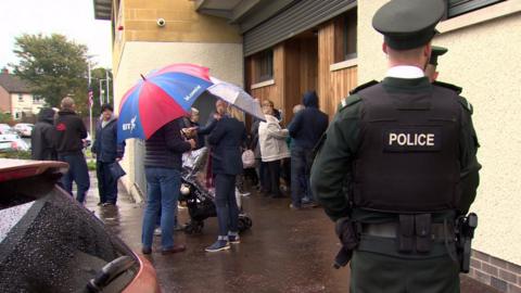 People outside residents' meeting