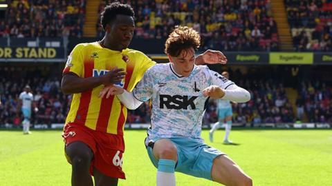 Footballer Nestory Irankunda competing for possession while playing for Watford Football Club against Charlton Athletic Football Club