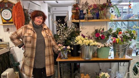 Ursula Stone with the flowers in her shop 