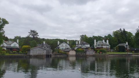 A general view of the Windermere Villas area. There are large houses on the shores of the lake, some with boathouses.