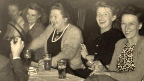 (Right to left) Selma van Gyseghem, Christina Helene Ardelheid Vermeirsch, Esther Vermeirsch and man (left with back to us) Albert van Gyseghem enjoying themselves at an unknown restaurant in Soho London in the early 1950's.