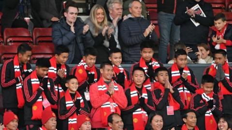 Thai coach Ekkapol Chantawong (C) and members of the "Wild Boars" football team