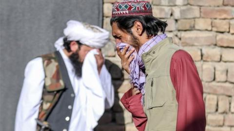 Worshippers react at the scene of an attack that targeted a mosque in the outskirt of Kabul, Afghanistan, 14 May 2021.