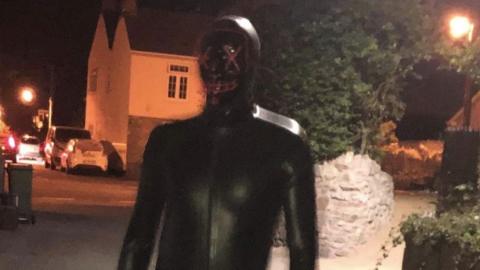 Man in gimp outfit