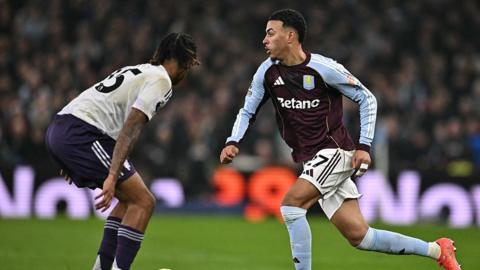 Manchester United defender Leny Yoro tries to stop Aston Villa's Morgan Rogers