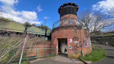 The entrance to the Cathedral and Quay car park through a small turret with ramped steps to the right.