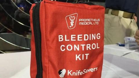 A red bag, with "Bleeding Control Kit" written on it.