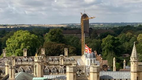 Cambridge skyline with University library, crane and fields in the background