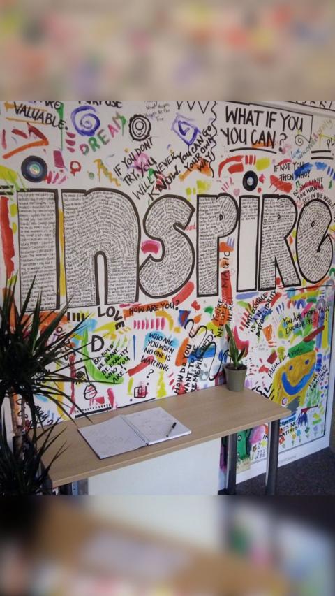 The word inspire written on a wall.
