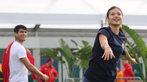 Carlos Alcaraz watches Emma Raducanu throw a ball at the Davis Cup and Billie Jean King Cup events in 2024