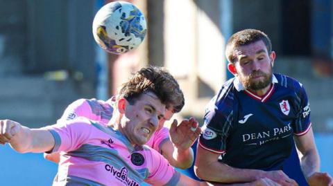 Partick Thistle and Raith Rovers players challenge for the ball