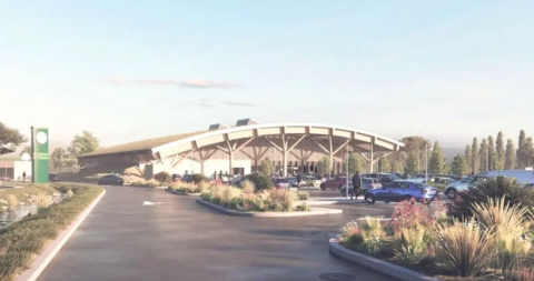 An AI-generated image of the new M4 service station site near Swindon with cars parked in a car park and a figure walking, illustrated with plants and trees in the background.