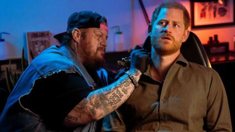 Singer Jelly Roll in a comedy sketch about giving Prince Harry a tattoo