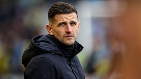 Portsmouth boss John Mousinho looks on from the sidelines