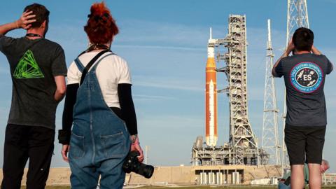 People taking photographs of the rocket