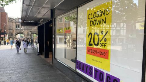 The window of House of Fraser on Lincoln's high street advertises reductions in the run up to the shop's closure