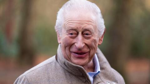 Image of King Charles. He is smiling while standing outside