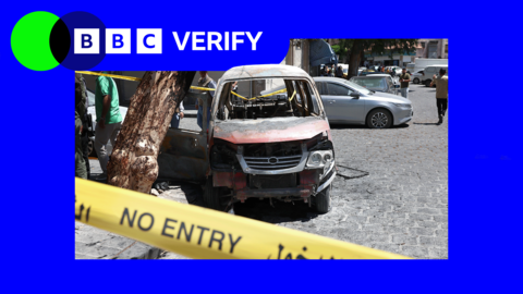 A heavily damaged car is seen in the aftermath of the bombing in Syria. It is left between police tape.