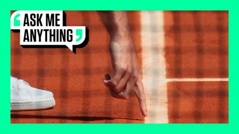 A line judge points to the line during play