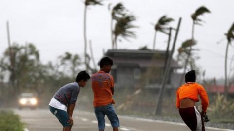 Boys are blown by strong winds in Baggao