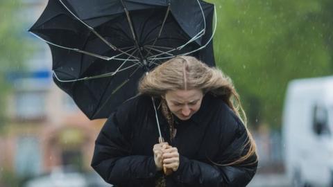 Blonde woman under umbrella