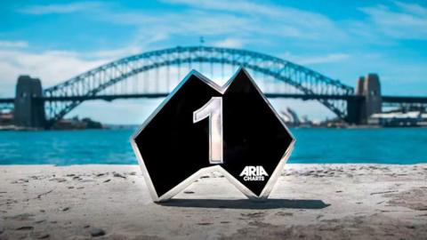 An Aria award pictured in front of the Sydney Harbour Bridge