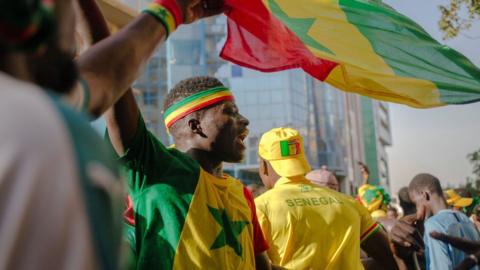 Man waves Senegalese flag