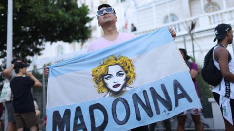A Madonna fan is seen in front of the Copacabana Palace hotel on Copacabana beach