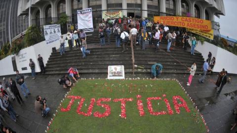 Relatives of the victims of the slaughter of the villa Dos Erres form the word 'Justice' with flowers outside the Supreme Court on August 2, 2011 in Guatemala City before the trial of military men involved.