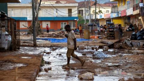 A person walks down a street affected by Hurricane Melissa; in Santa Cruz, Jamaica, 30 October 2025.