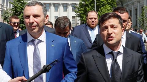 Ukraine's President Volodymyr Zelenskiy (R) walks from the parliament to the presidential administration office accompanied by his aide Serhiy Shefir