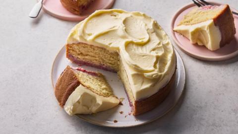 A cake with two slices taken out of it. The cake is topped with a white icing