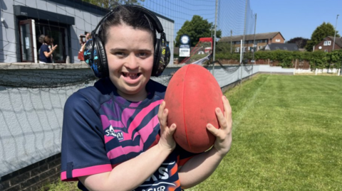 Kathryn York, 23, holds a rugby ball 