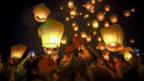 People releasing lanterns during celebrations in Pingxi, New Taipei City, Taiwan.