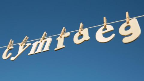 The Welsh-language word for Welsh, Cymraeg, with the letters on a clothes line