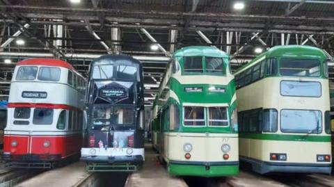 Four heritage trams lined up in the Tramtown museum based on Rigby Road, Blackpool.