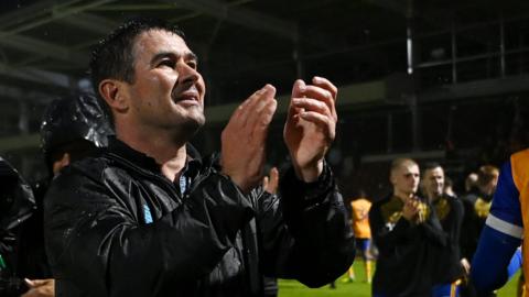 Nigel Clough applauds fans after Mansfield beat Northampton