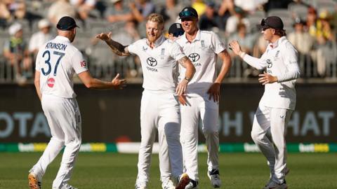 Ben Stokes celebrates with teammates after taking a wicket
