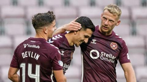 Hearts' Alexandros Kyziridis celebrates with Cammy Devlin (L) and Stephen Kingsley (R)