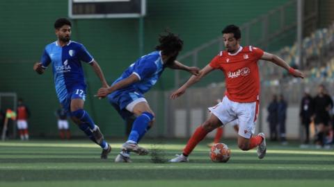 Action from Al Ahly Benghazi (in red) against Al Hilal in the Libyan league