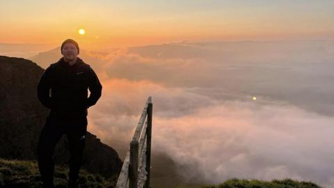 Danny Caldecott stood with a cloud inversion behind him