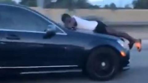 Man on top of car