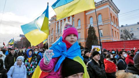 A child holding a Ukrainian flag