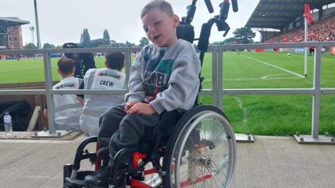 Louis Perrin in his wheelchair at Wrexham's Racecourse Stadium